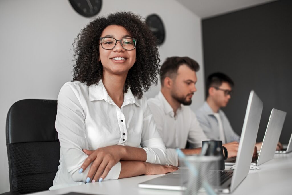 positive-black-businesswoman-near-male-colleagues